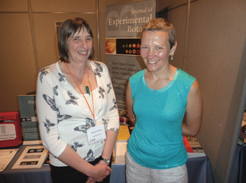 Christine and Mary smiling in front of a JXB poster at the SEB Conference.