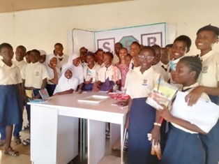 Group of children posing with a poster